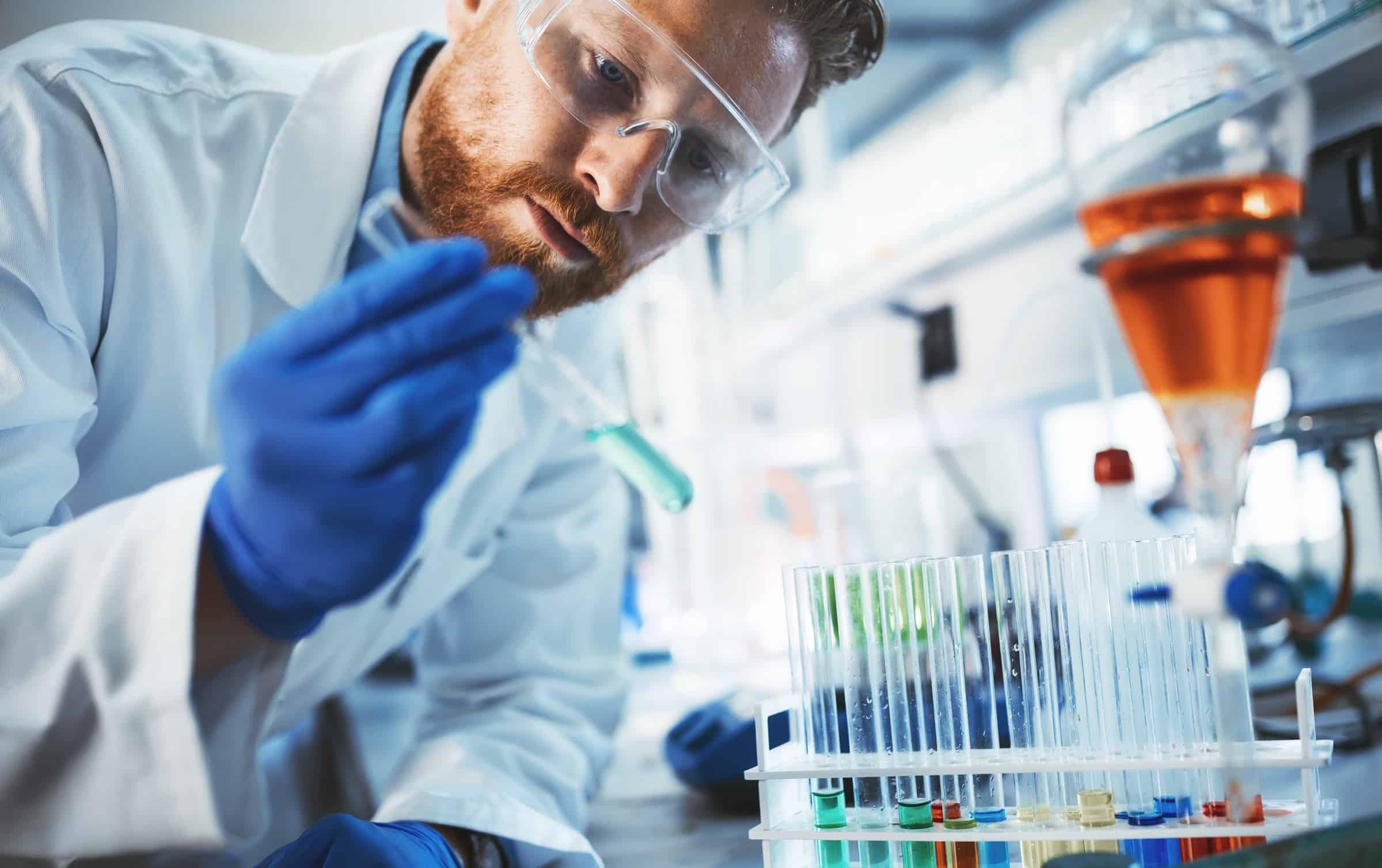 man in lab working with chemicals